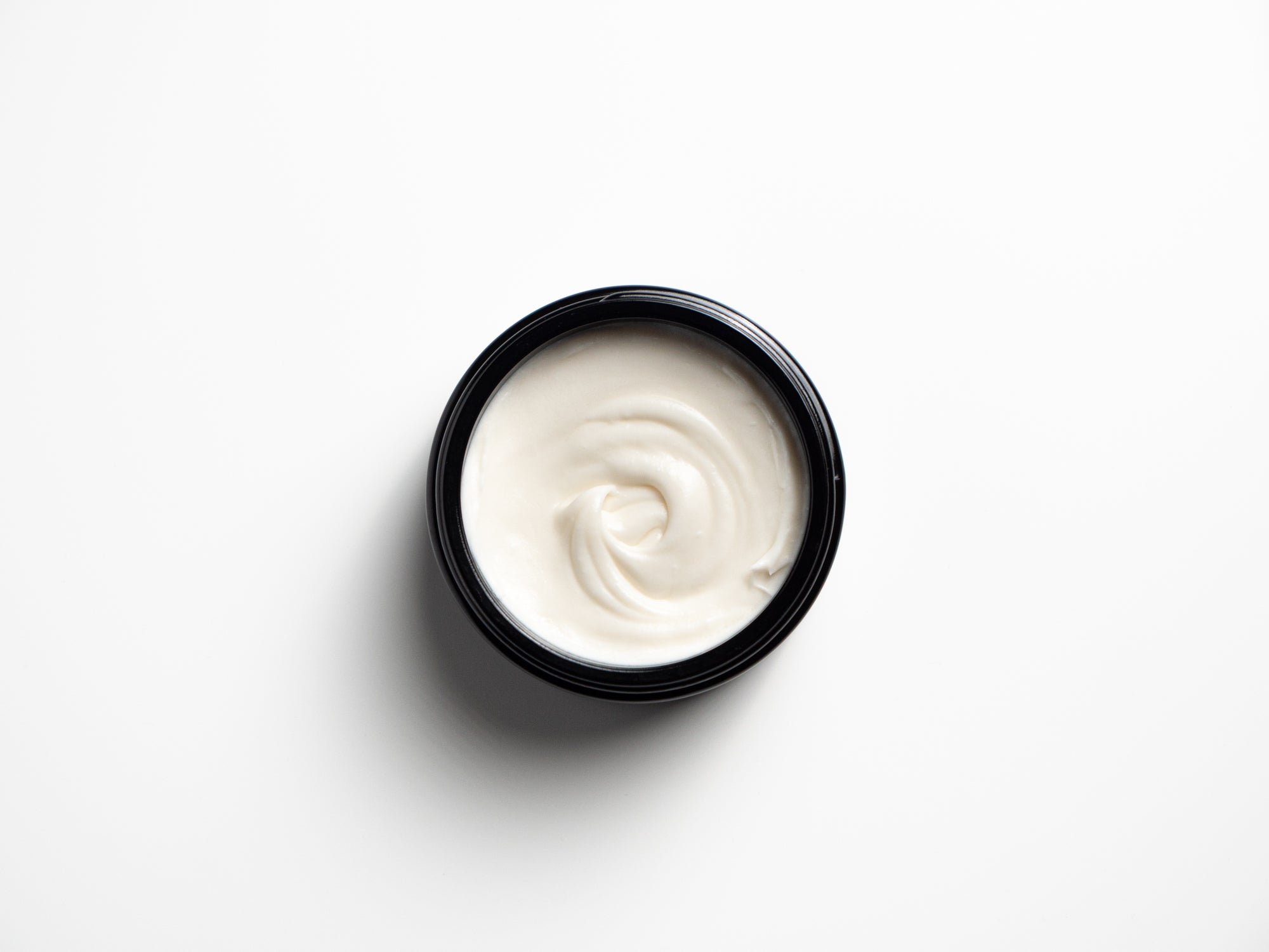 Open jar of Helichrysum Body Cream showing its white creamy texture