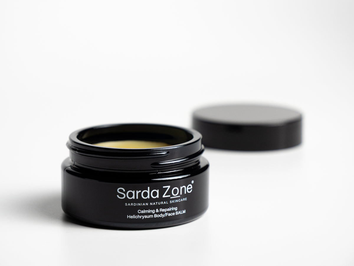 Open jar of Sarda Zone Helichrysum Body/Face BALM on a white background with the lid behind it