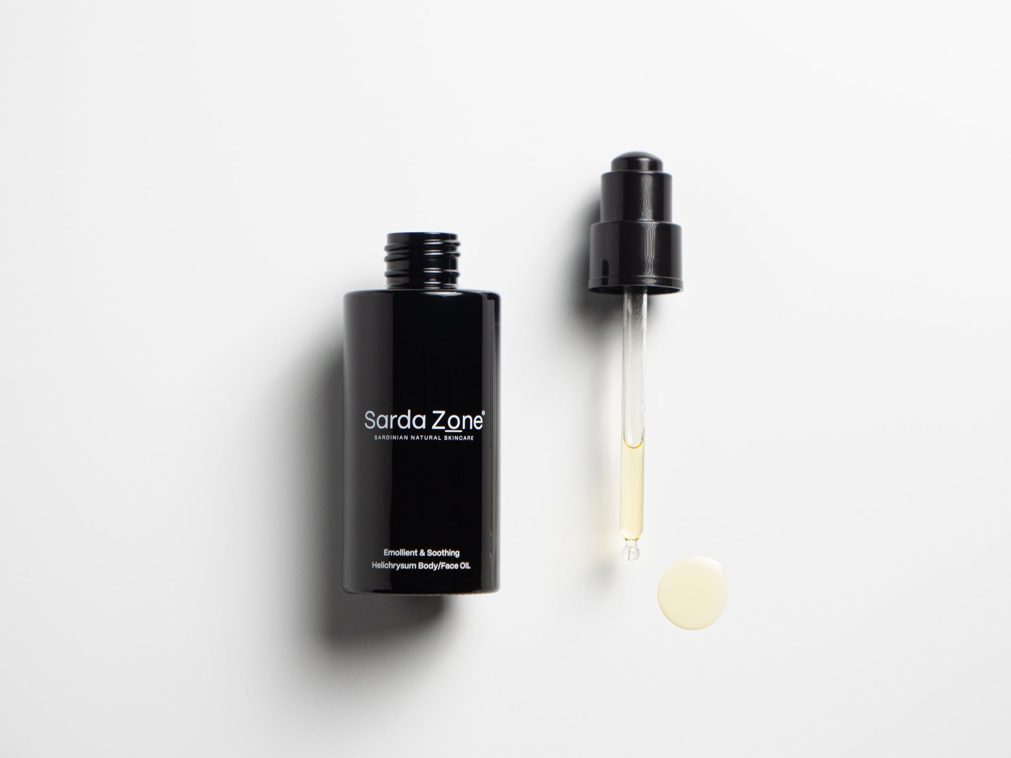 Open bottle of Sarda Zone Helichrysum Body/Face OIL with a glass dropper